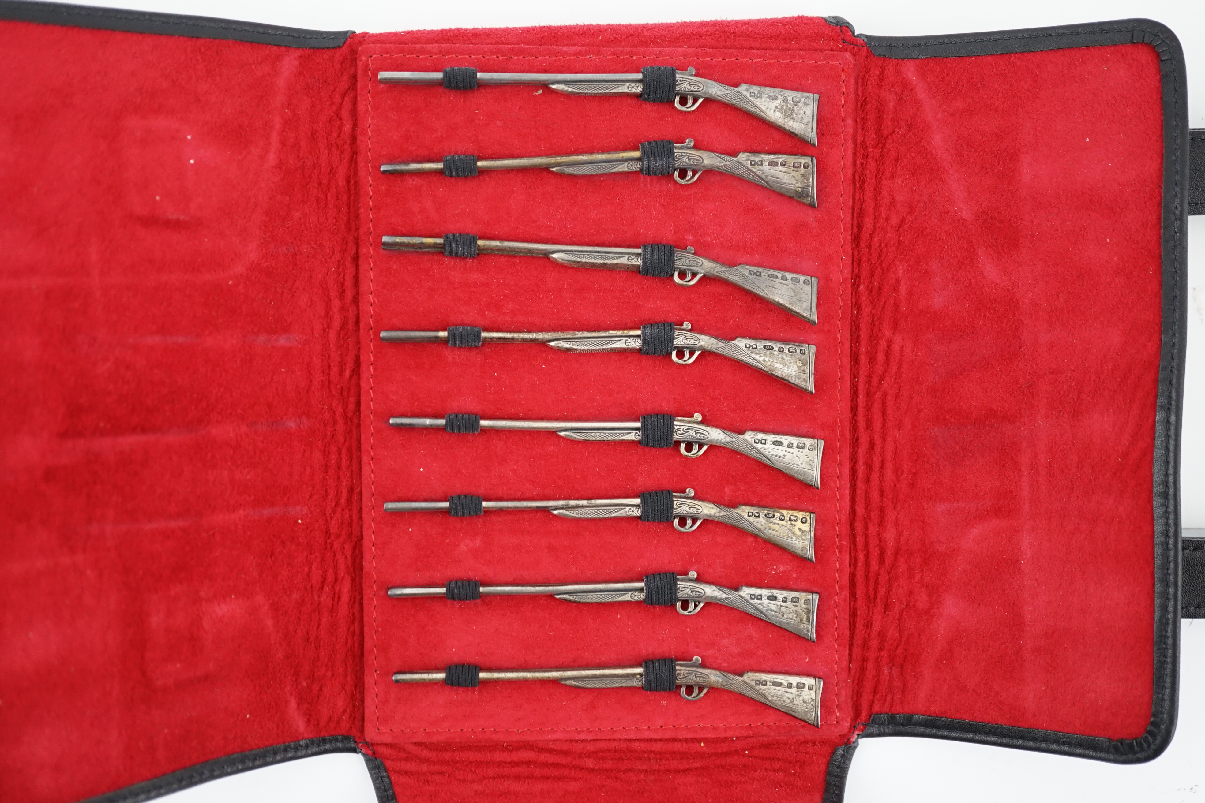 A modern set of eight novelty silver butt markers, modelled as double barrelled shotguns